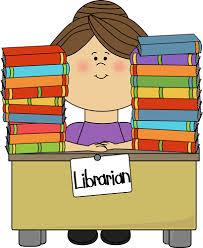 Librarian sitting at a desk between two stacks of books. 