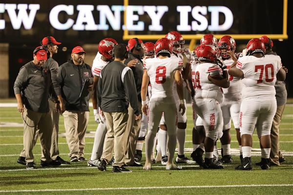 Team huddles on the field